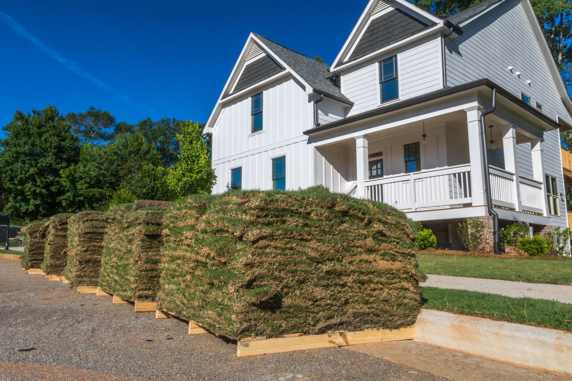 A pile of rolls of turf sitting on top of each other in a park.