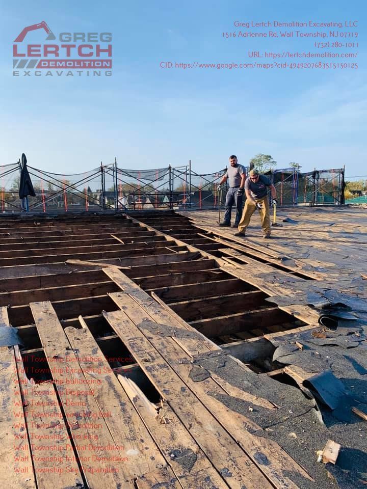 Two men are working on a wooden deck