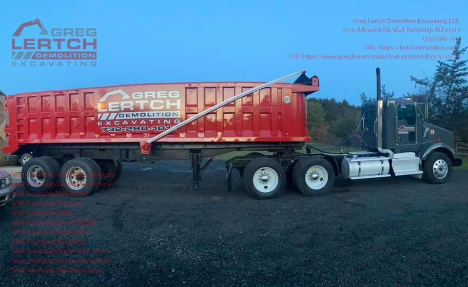 A large red dump truck is parked in a parking lot