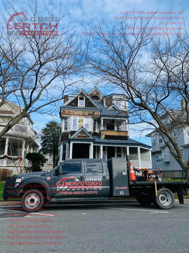 A truck is parked in front of a large house