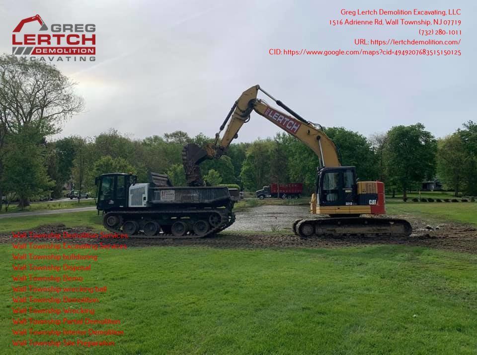 A large excavator is digging a hole in a grassy field