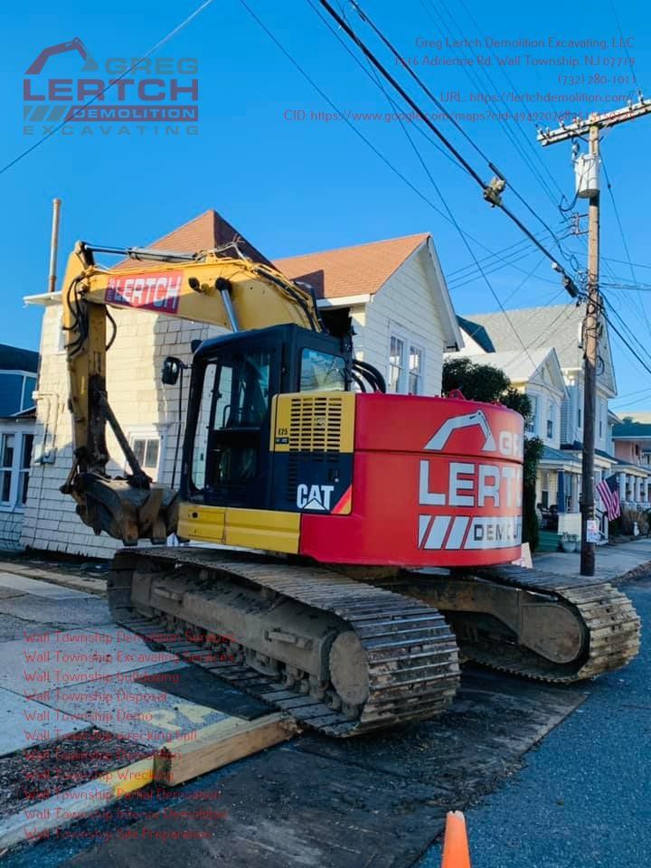 A cat excavator is parked on the side of the road