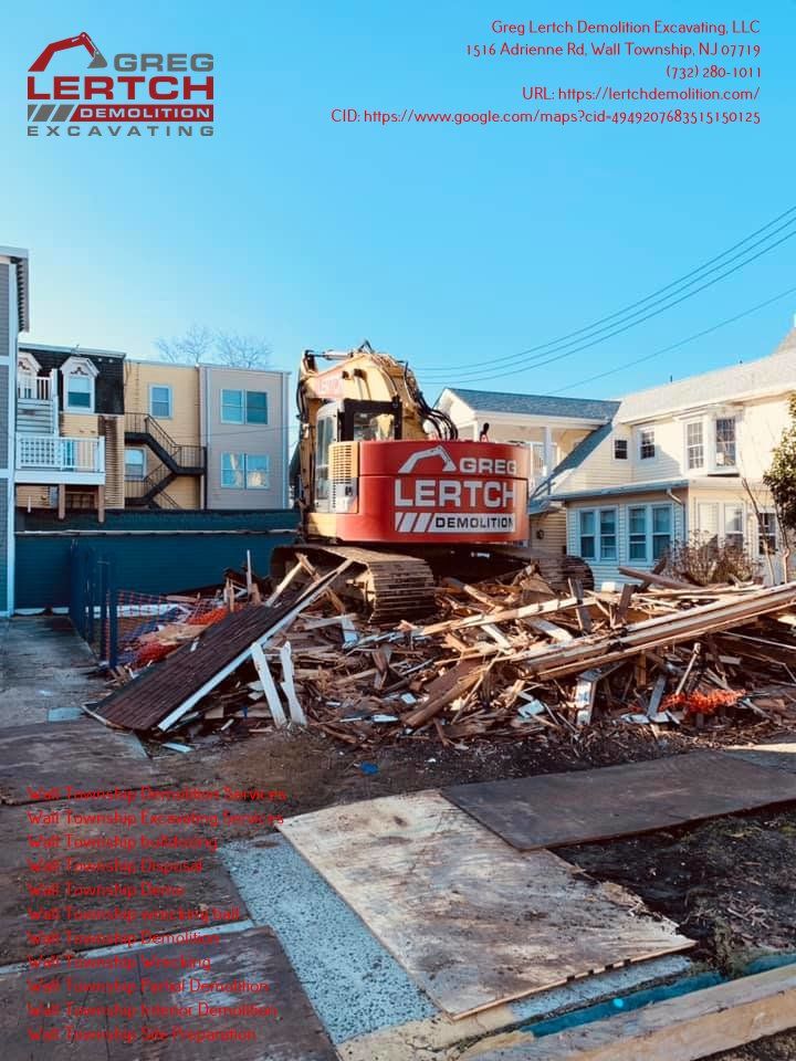 A red and yellow excavator is demolishing a building.
