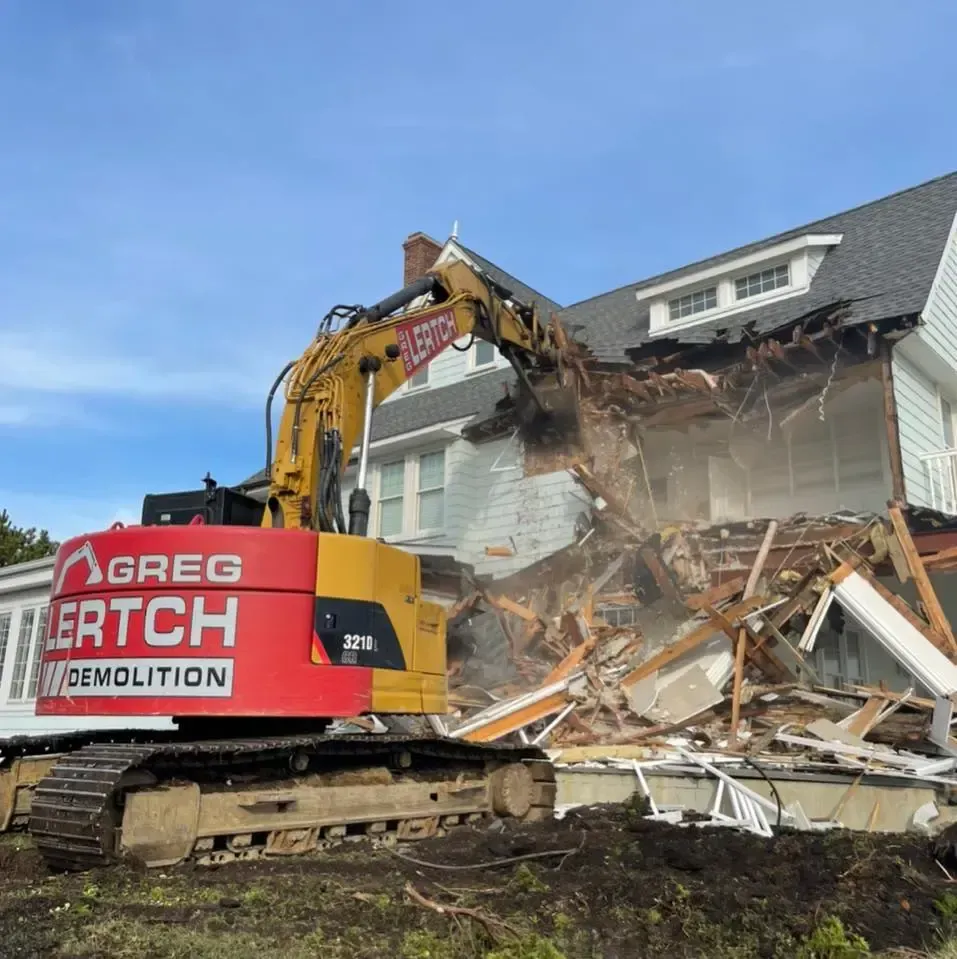 demolition contractor destroying house