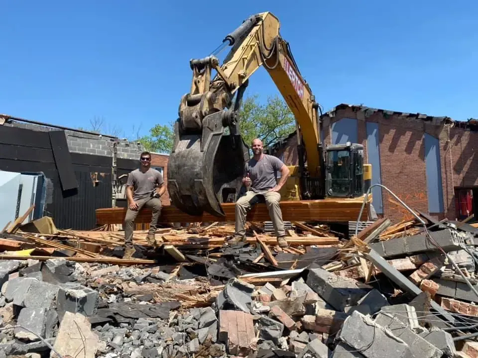 2 Guys on a Standing Behind an Excavator