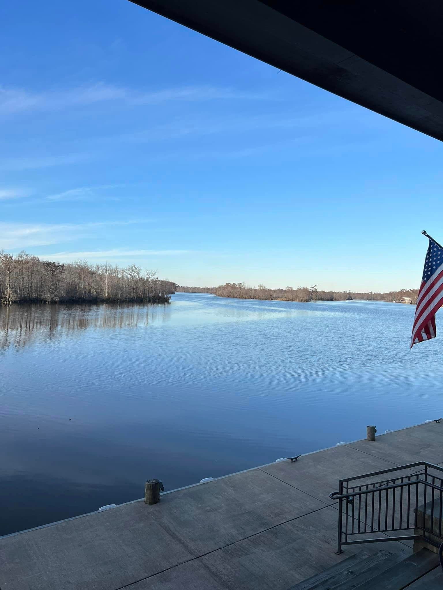 An american flag is flying over a body of water