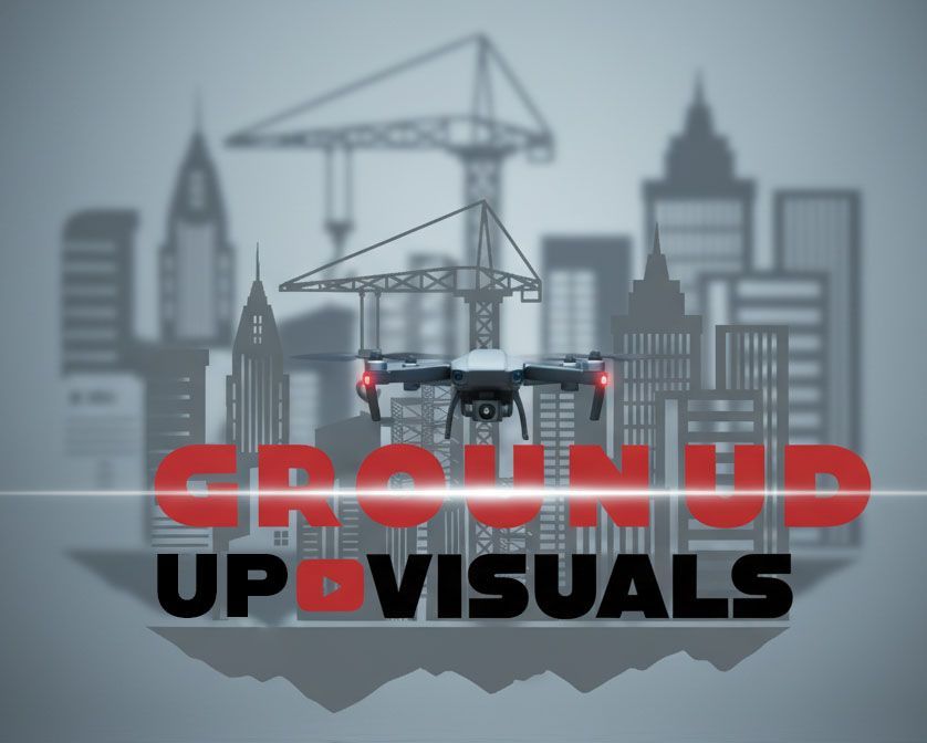 Drone over city skyline with “Ground Up Visuals” logo and construction cranes