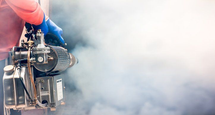 A Man Using Fumigation Mosquitoes Machine — Charlotte, NC — NuEra Pest Control