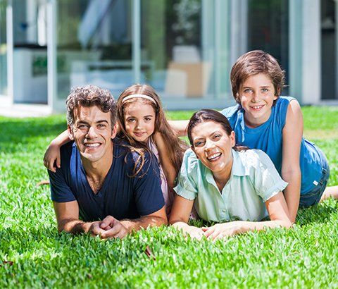 Family on Backyard Green Grass — Charlotte, NC — NuEra Pest Control