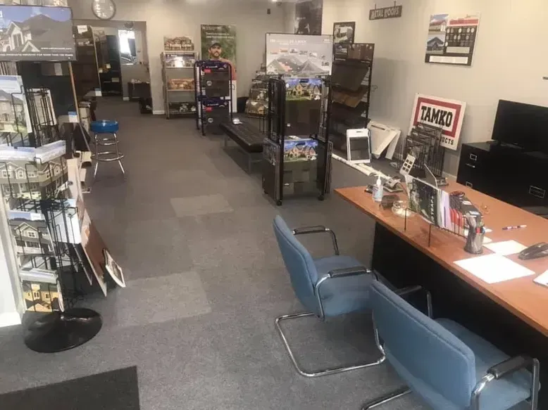 An office interior with brochures, desks, and chairs.