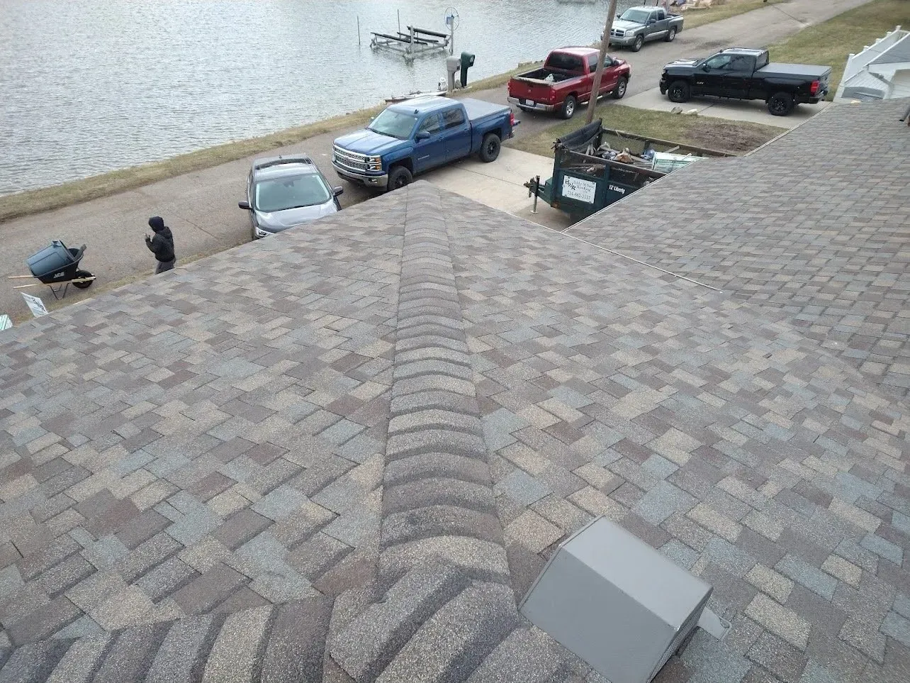 Overhead view of a roof with brown and gray shingles.