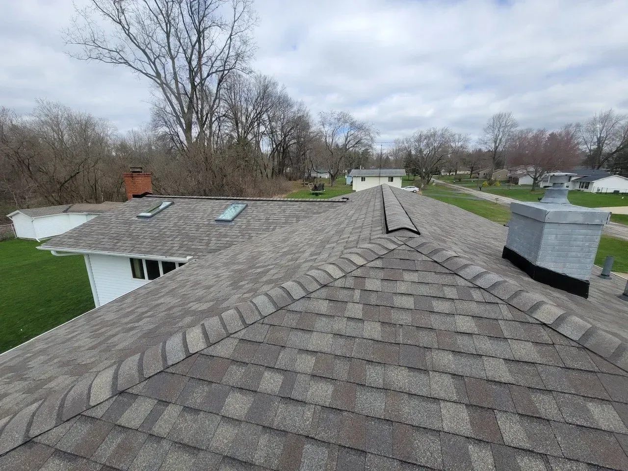 Overhead view of a house roof covered in gray shingles.