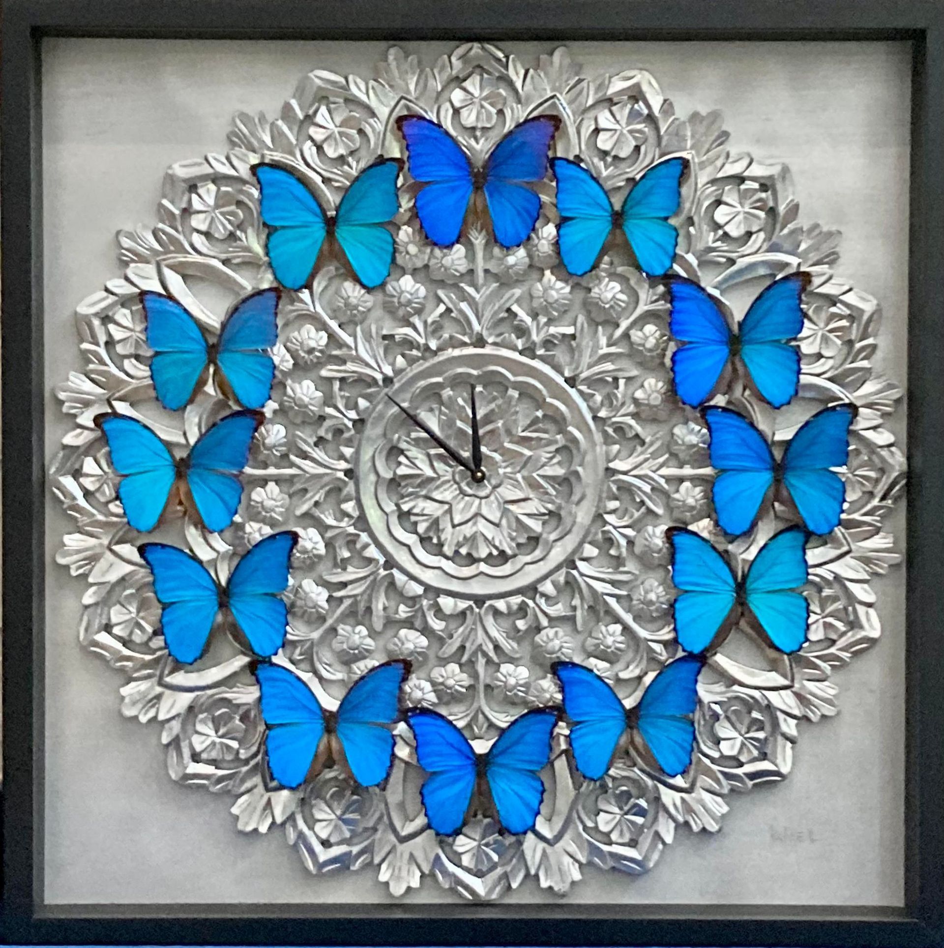 A clock surrounded by blue butterflies shows the time as 4:20