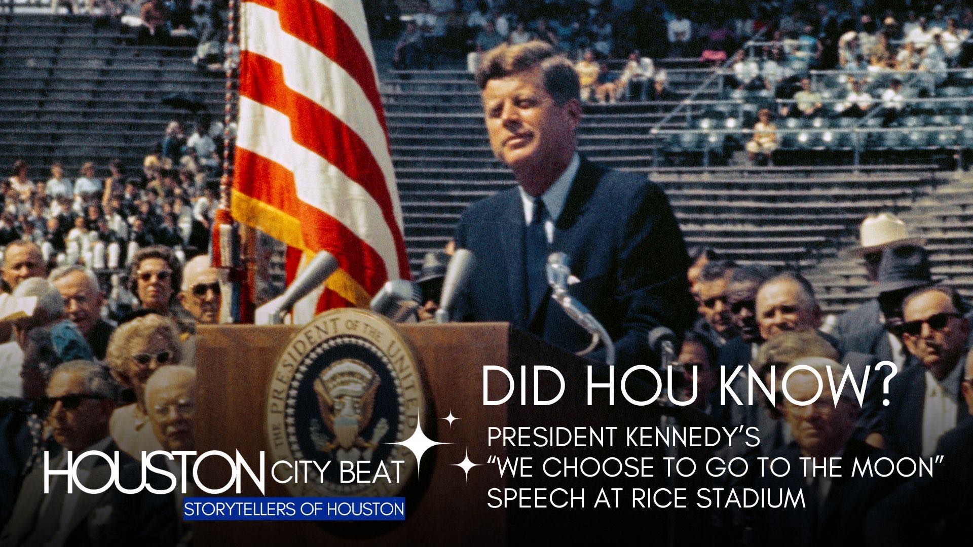 A man stands at a podium giving a speech in front of an american flag.