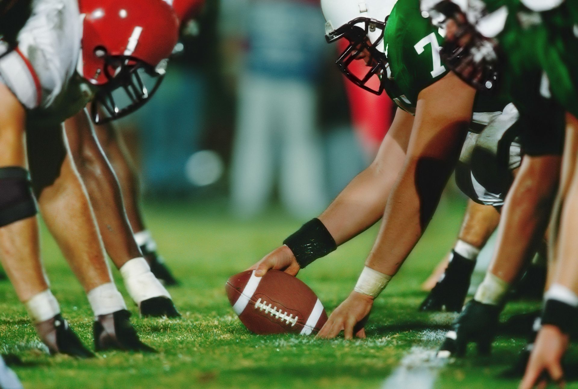 A group of football players getting ready to start a game