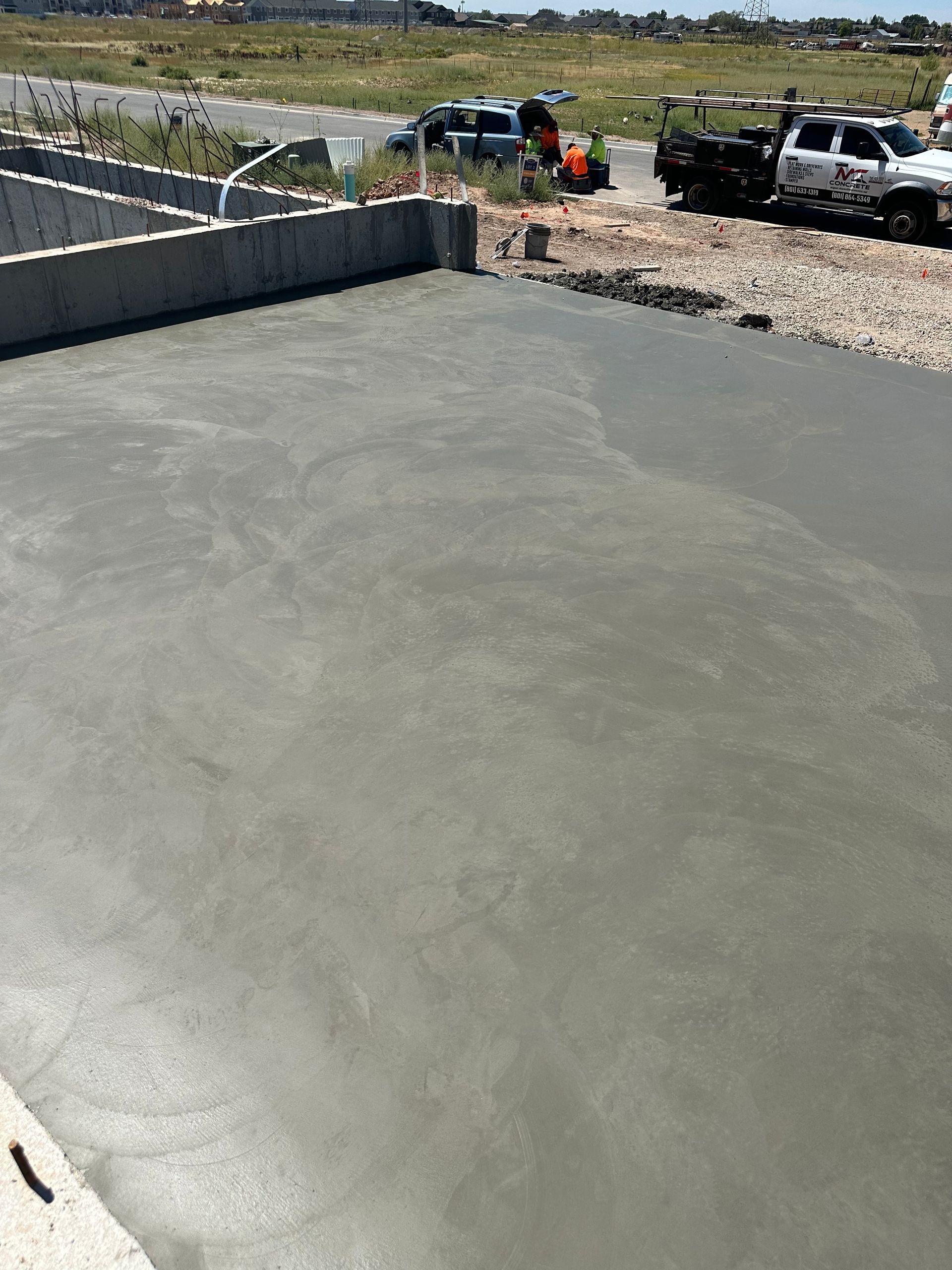 Freshly poured concrete surface; construction site, light gray.