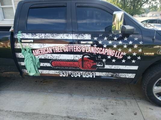 A black truck with american tree cutters and landscaping llc written on the side