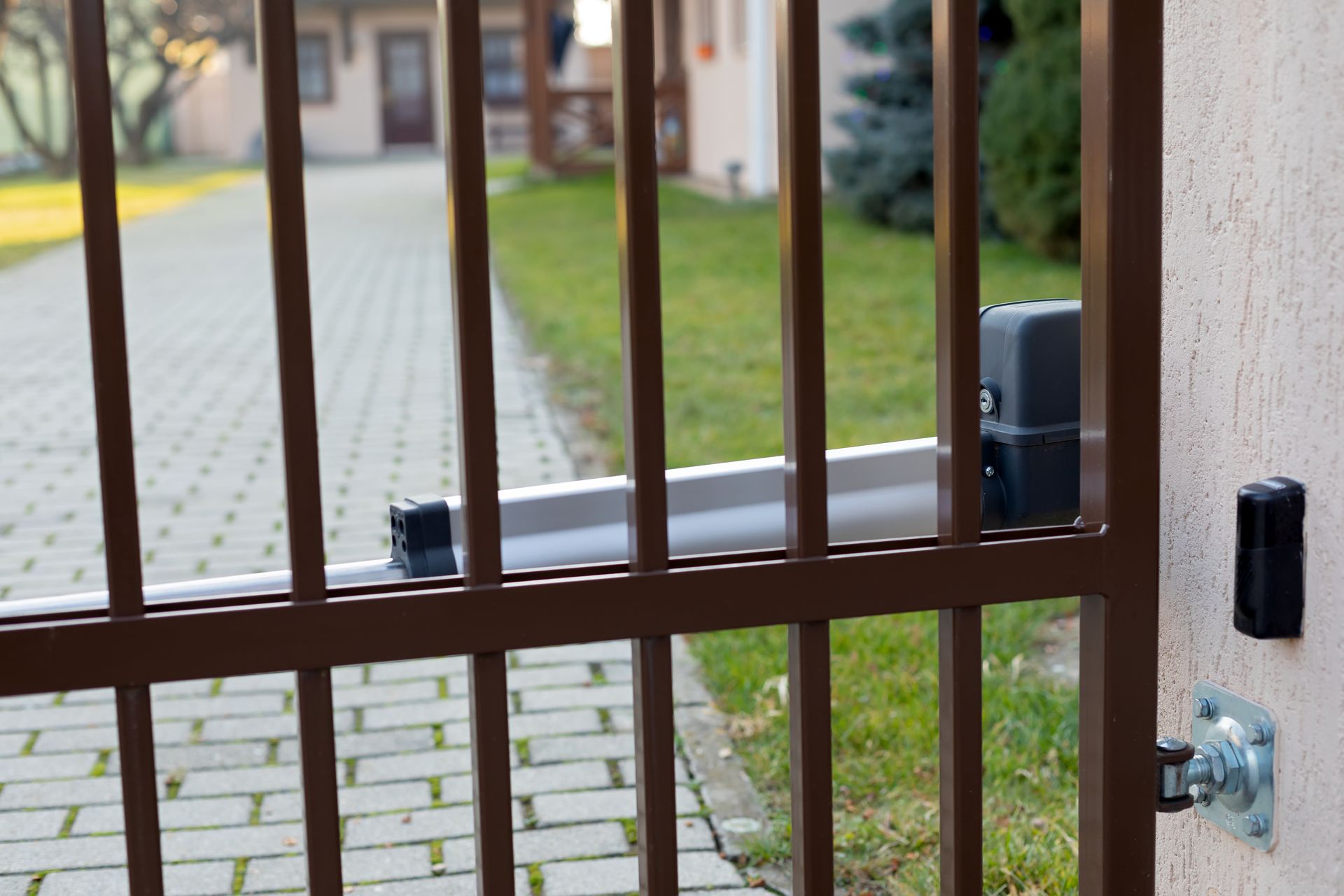 Woman in straw hat smiles, holding wine glass near a lake.