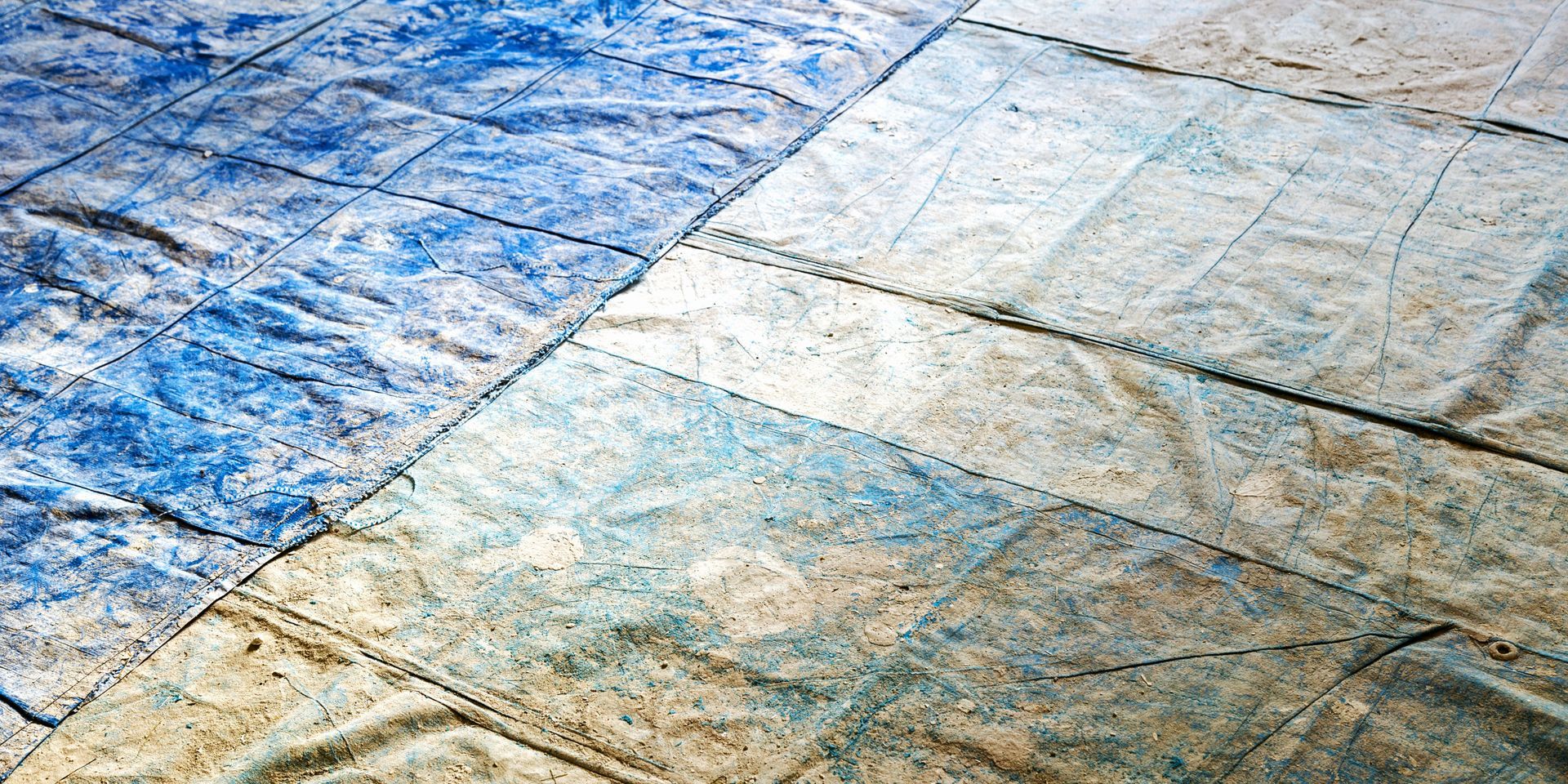 Blue and tan square tiles, angled view, textured surface.