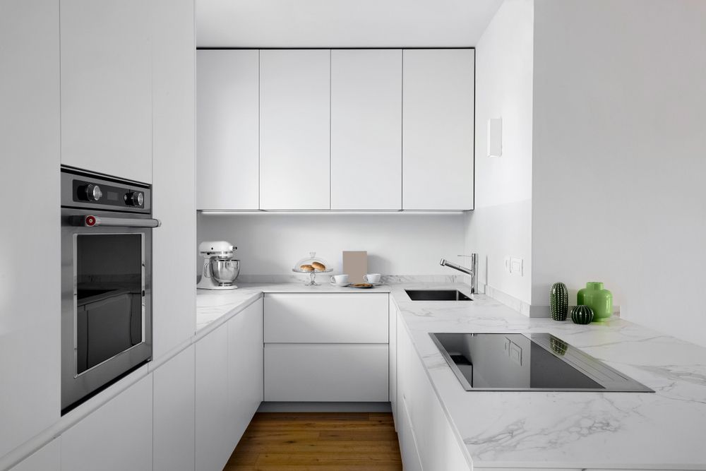 A Modern White Kitchen With Marble Countertops — Kitchens Factory Direct in Port Macquarie, NSW