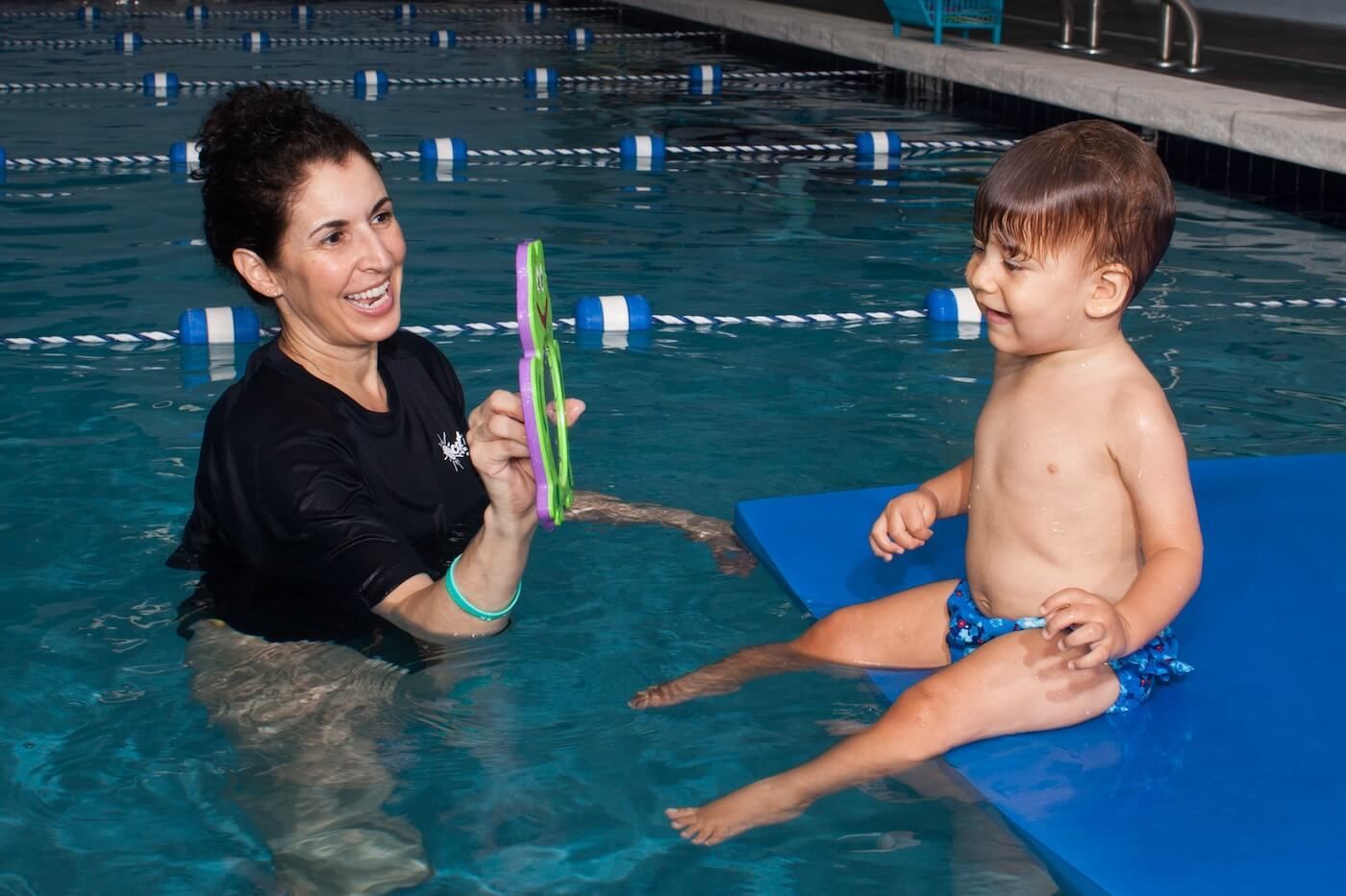 Instructor and boy in the pool