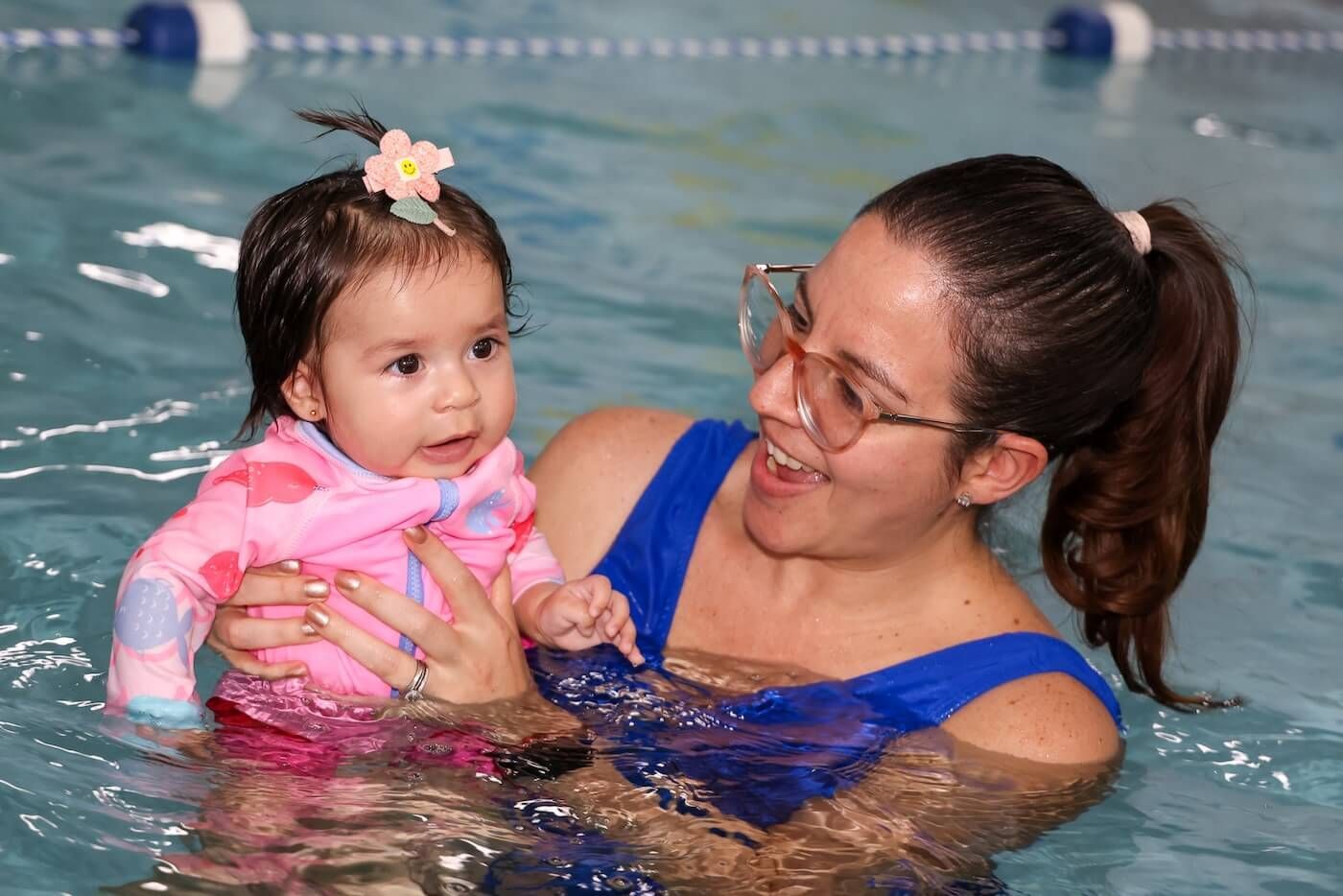 Baby and trainer swiming class