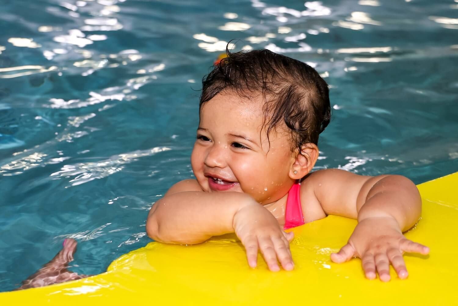 Baby at the topside of the pool