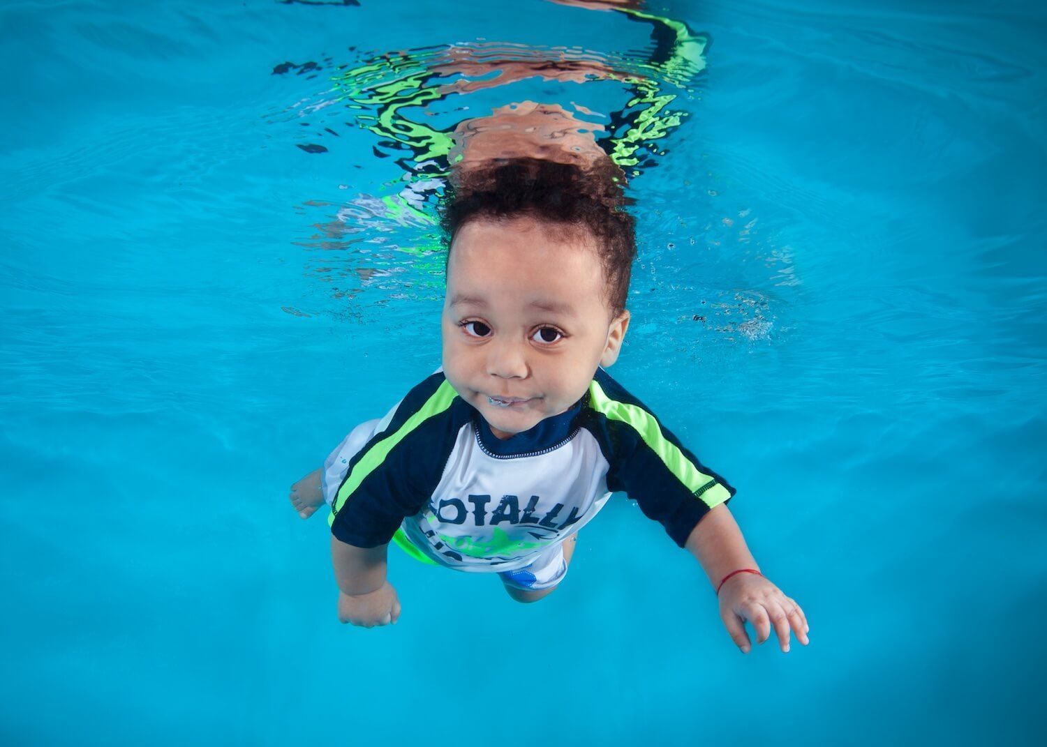 Child swimming by his own