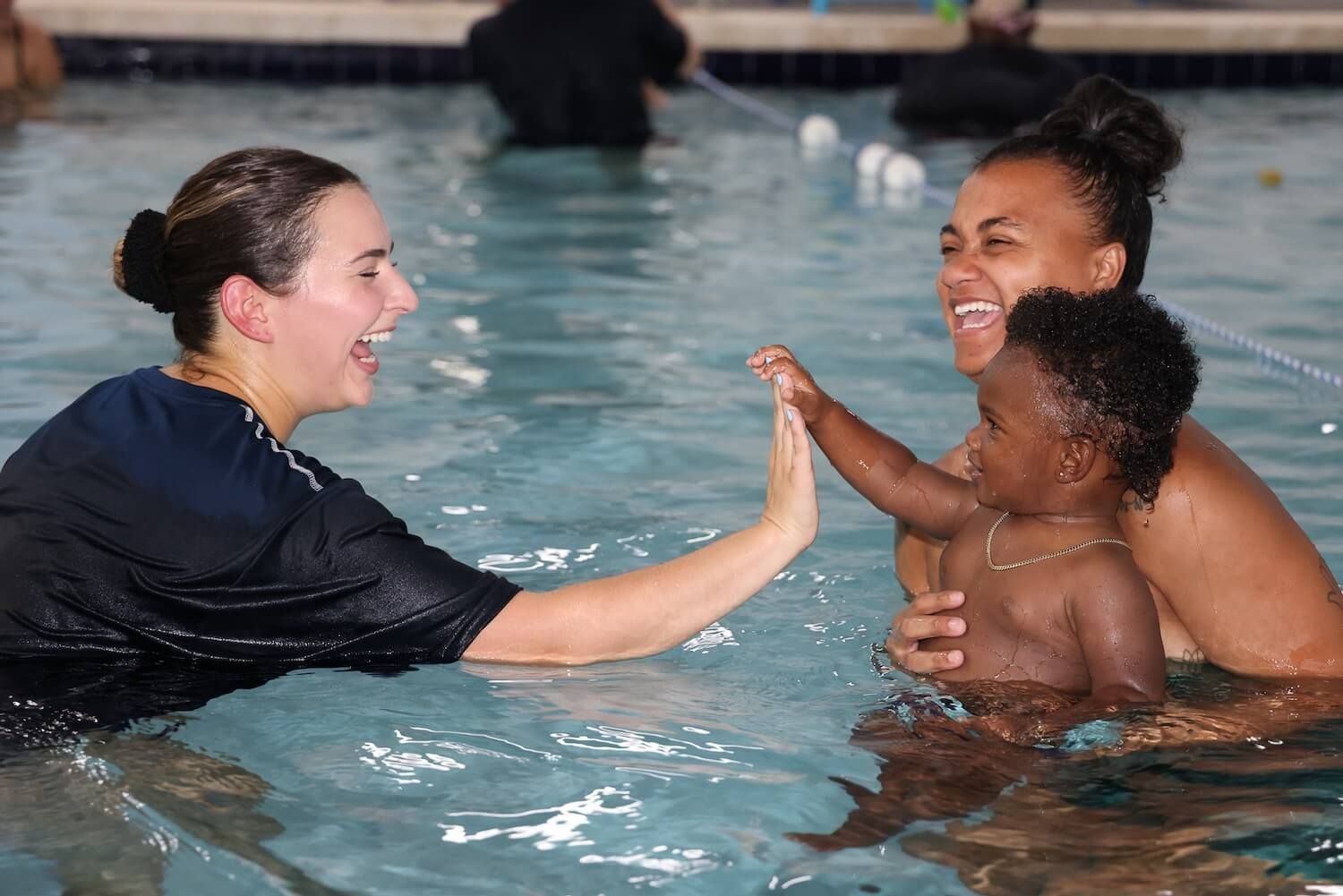 Instructor and baby high five