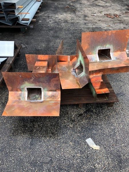 A pile of rusty metal pieces sitting on top of a wooden pallet.
