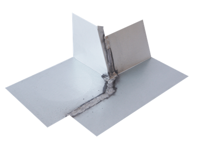 A piece of metal with a hole in it is sitting on a white surface.