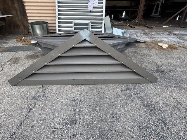 A metal structure is sitting on the ground in a garage.