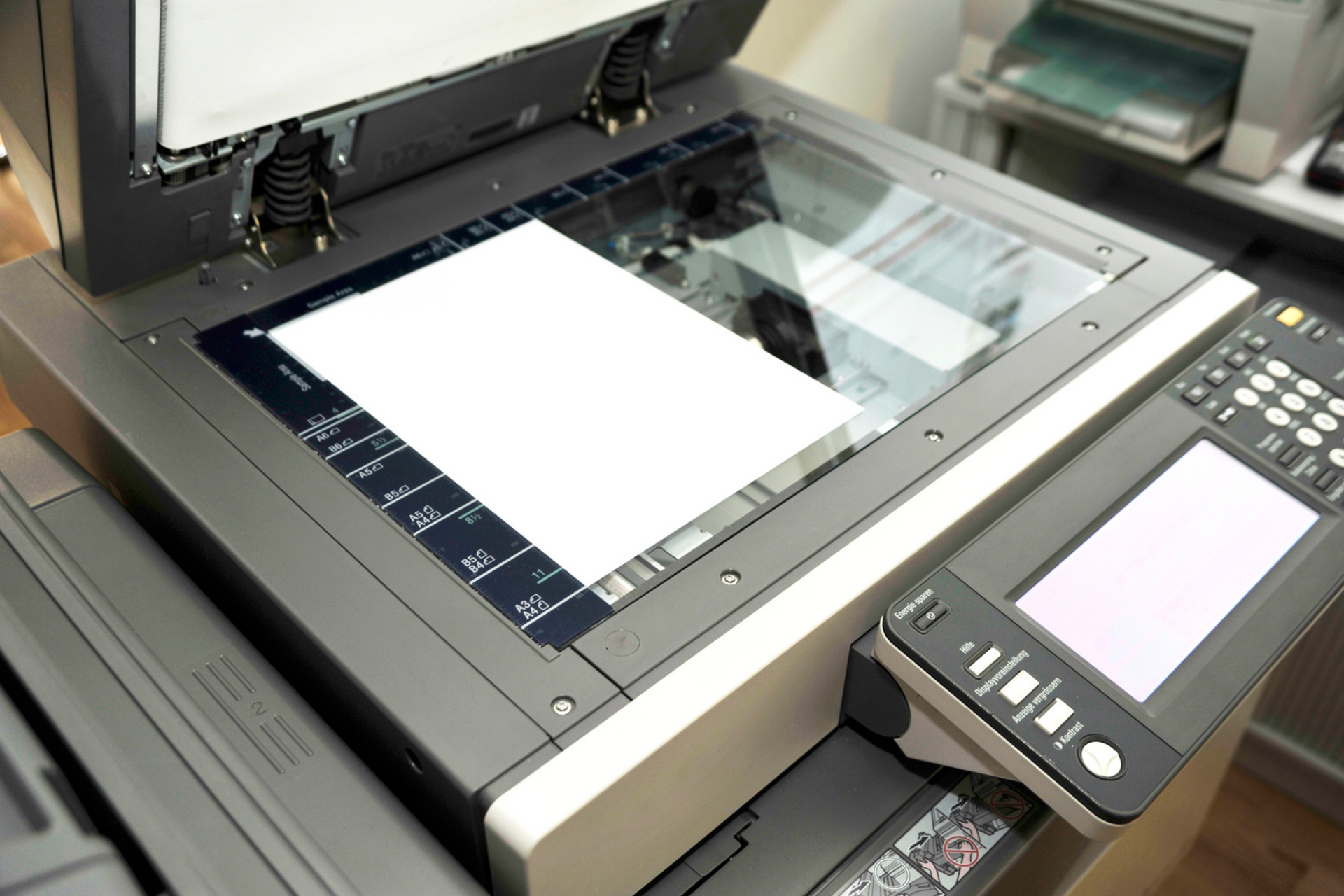 Hand pressing a button on a photocopier.