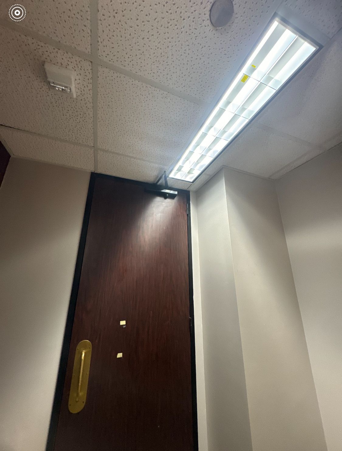 A room with a door and a light on the ceiling.