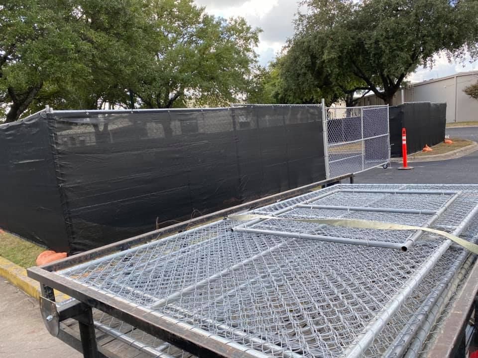 Metal fencing is sitting on top of a trailer.