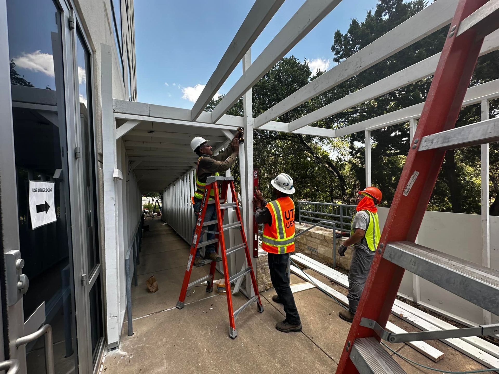 A group of construction workers are working on a safety pedestrian walkway
