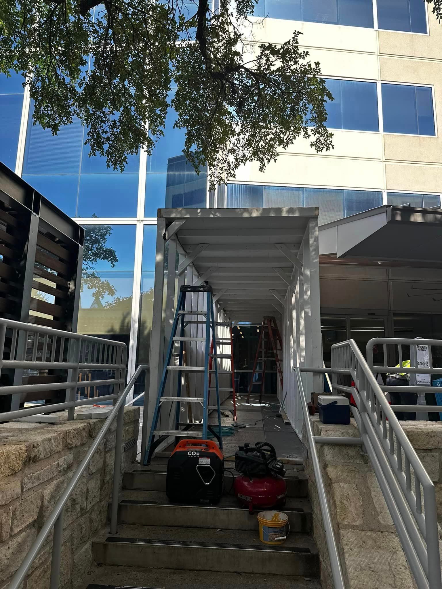 A building under construction with a safety pedestrian walkway under construction