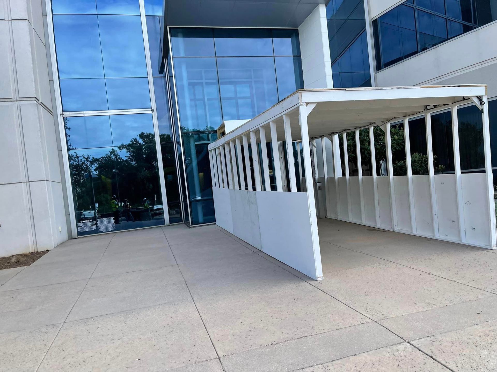 A safety pedestrian walkway leading to a building with a lot of windows