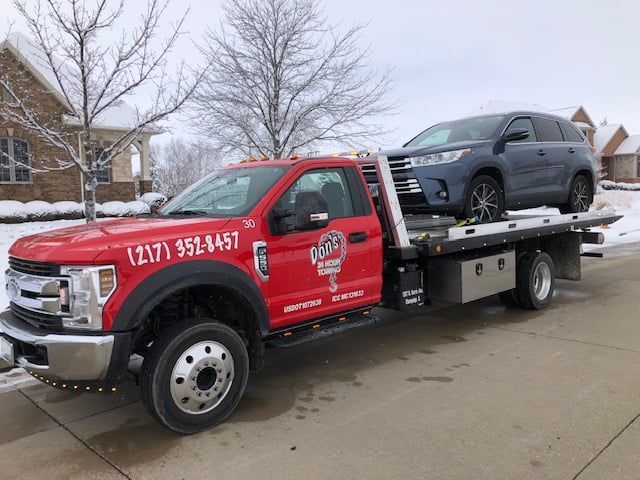Towing A Dark Blue Car — Champaign, IL — Don’s 24 Hour Towing