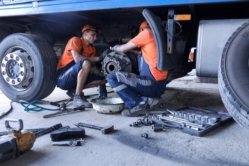Two Men Are Working on a Truck in a Garage — Coffs Coast Mobile Mechanical in Toormina, NSW