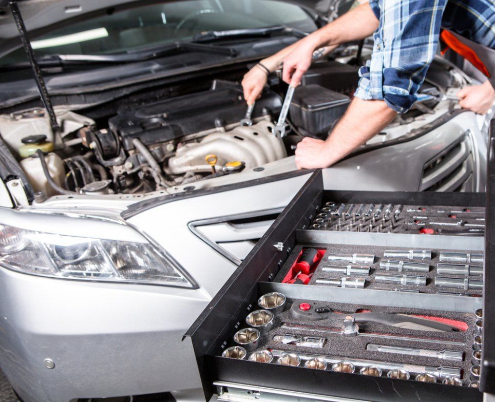 A Man is Working on the Engine of a Car — Coffs Coast Mobile Mechanical in Woolgoolga, NSW
