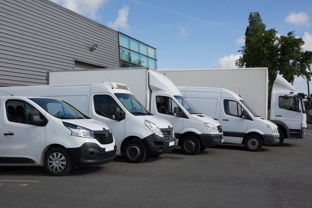 A Group of Vans Parked in Front of A Building — Coffs Coast Mobile Mechanical in Toormina, NSW