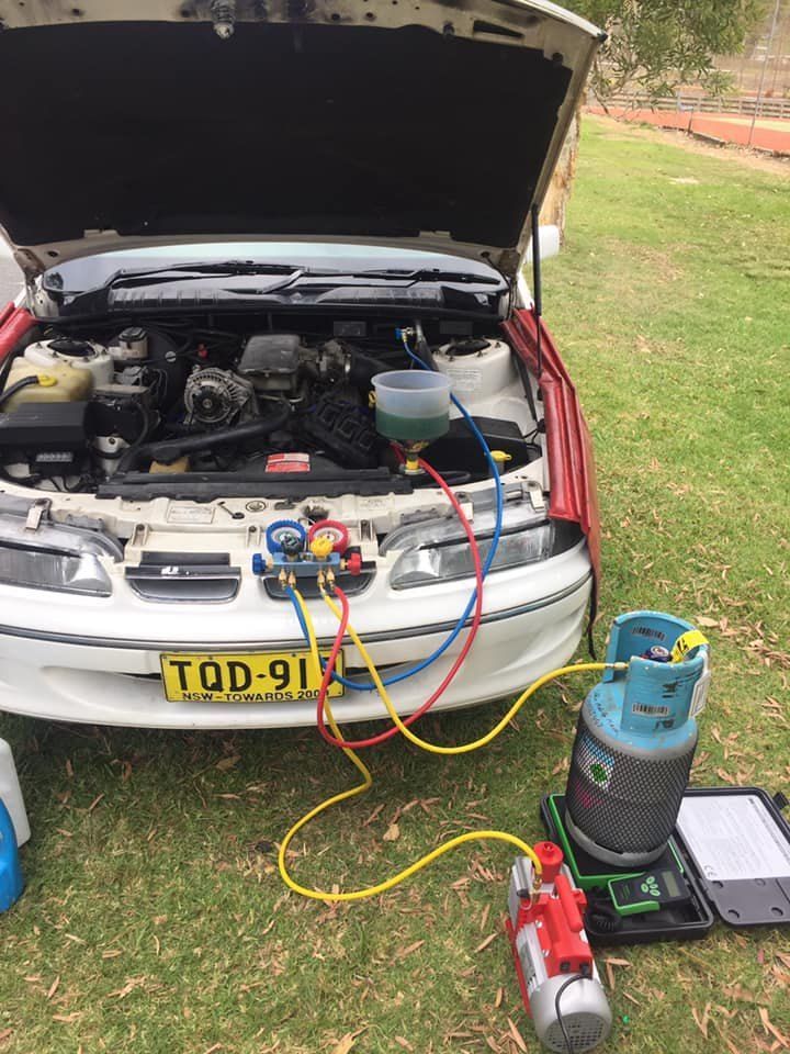 A Car is Being Serviced With the Hood Open — Coffs Coast Mobile Mechanical in Toormina, NSW