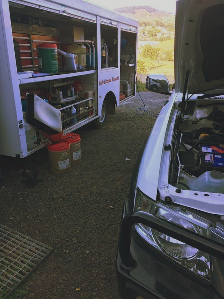 A White Truck With the Hood Open is Parked Next to a White Truck — Coffs Coast Mobile Mechanical in Toormina, NSW