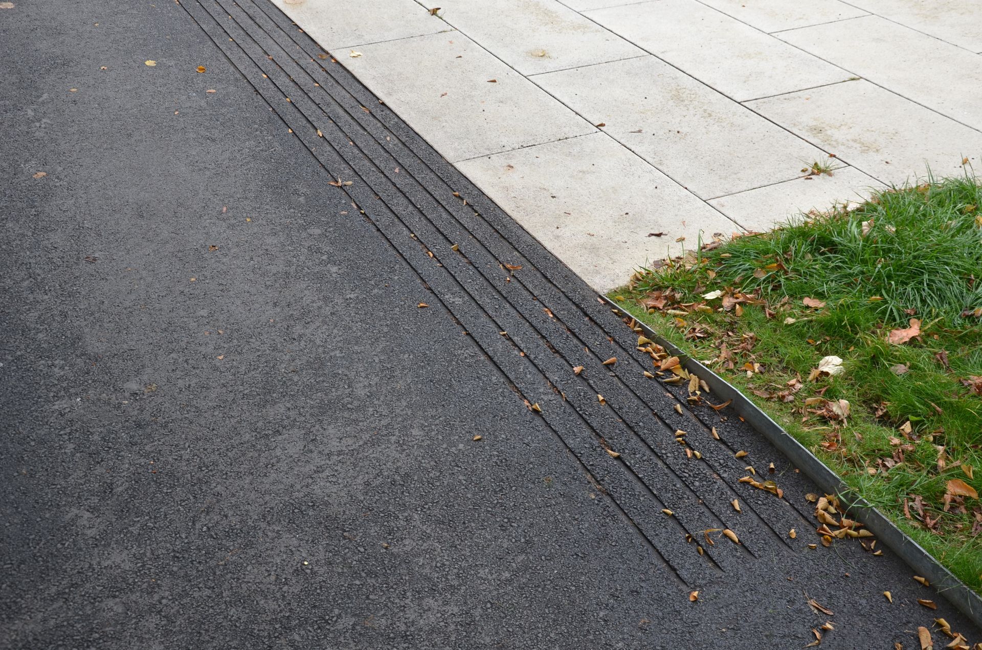 An asphalt street surface with safety grooves.