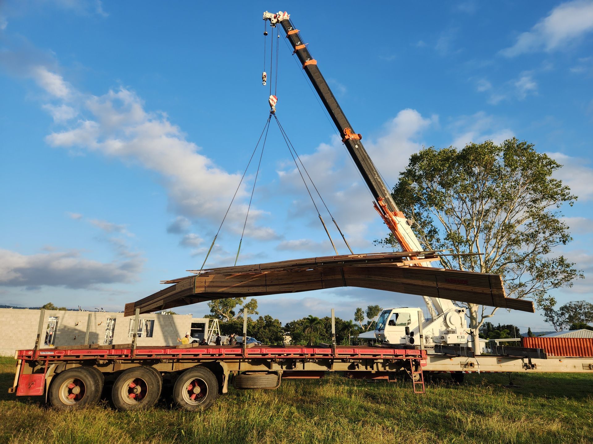 A White And Red Truck With A Crane On Top Of It — J & D Rigging Pty Ltd In Bohle, QLD