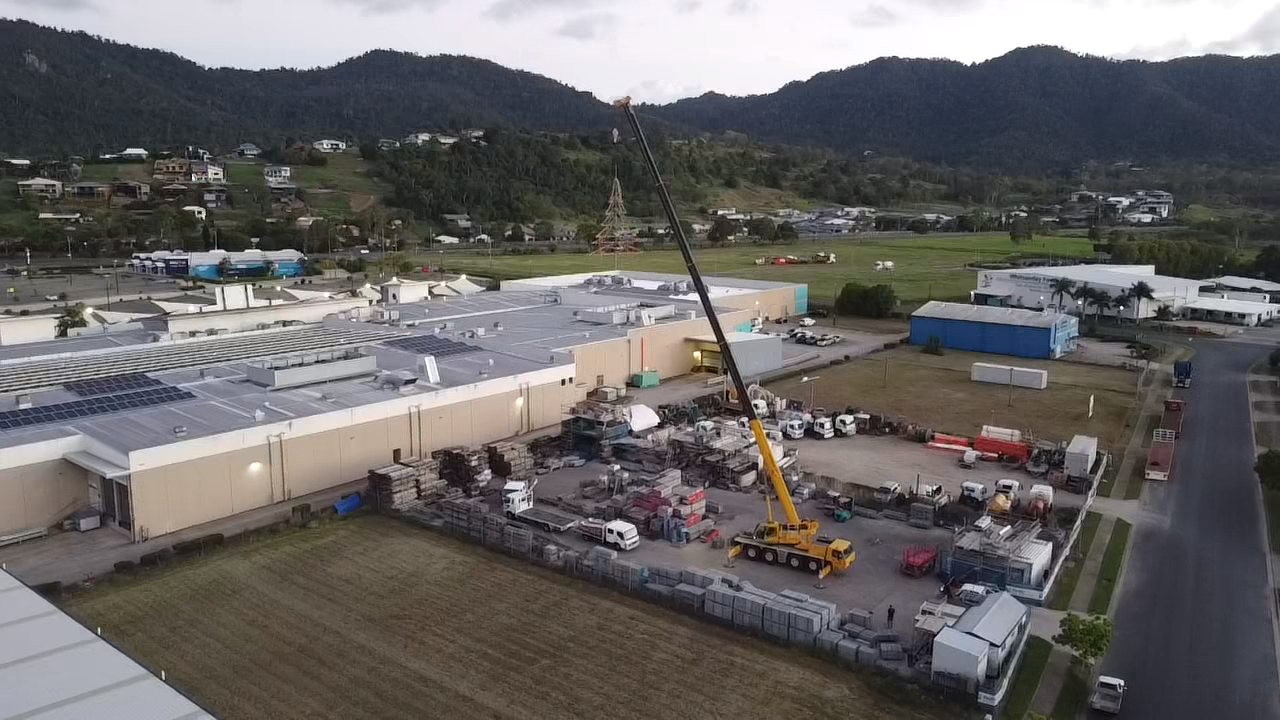 A Yellow Crane Is Sitting On Top Of A Construction Site — J & D Rigging Pty Ltd In Bohle, QLD