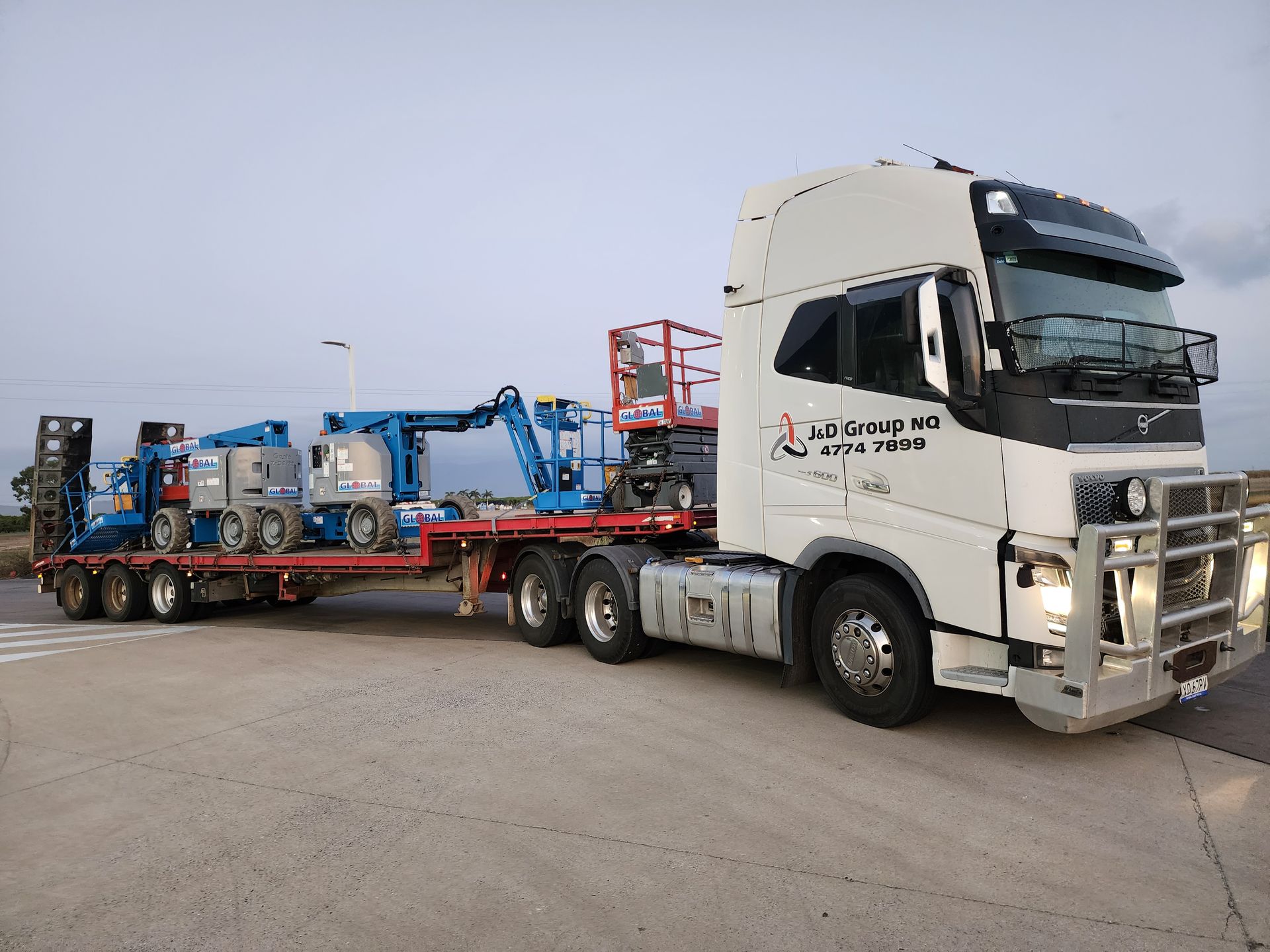 A Group Of Construction Workers Are Working On A Building — J & D Rigging Pty Ltd In Bohle, QLD