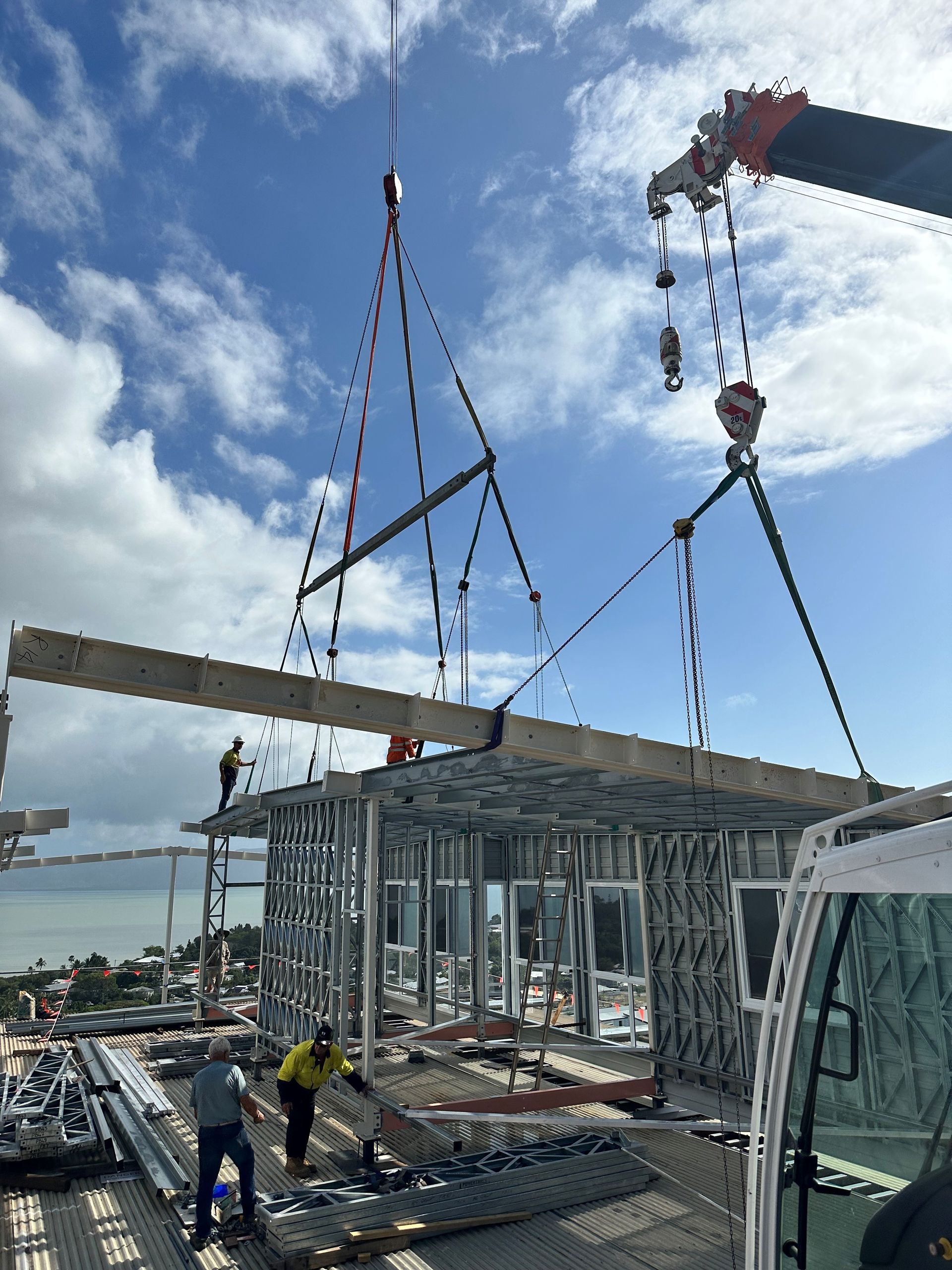 A Large Yellow Crane Is Sitting On Top Of A Construction Site — J & D Rigging Pty Ltd In Bohle, QLD