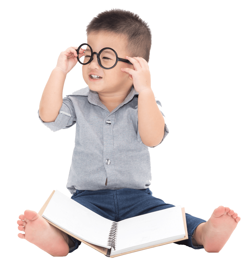 Boy sitting with book — Verona, WI — Once Upon a Time Childcare Center